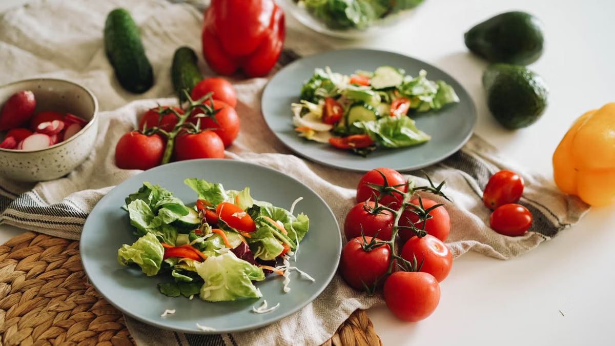A vibrant plate of fresh salad featuring cherry tomatoes, avocado, and colorful veggies.